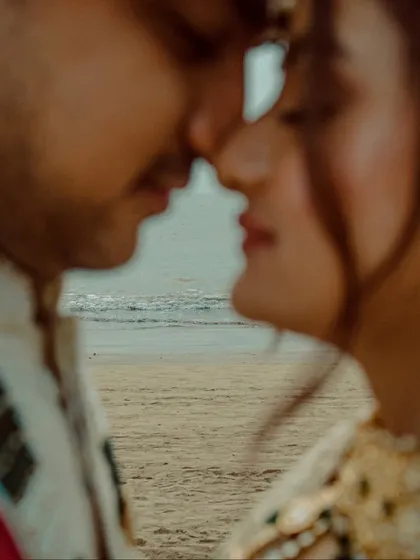 A creative focus pull places the ocean between the couple's lips, a unique and artistic shot from a beach wedding portrait session. It’s these creative risks that result in unforgettable images.