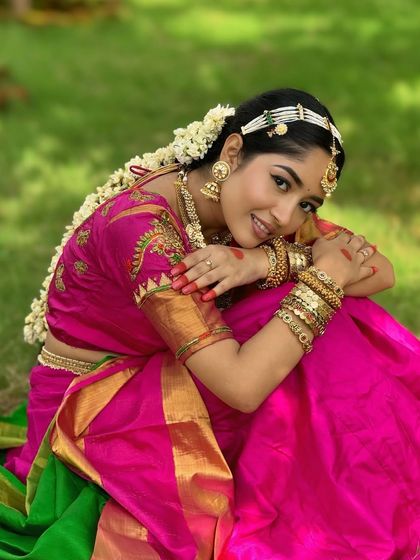 A close-up that speaks for itself. The makeup is minimal yet impactful, with defined eyes and glowing skin that enhances her natural beauty, letting the traditional attire shine.