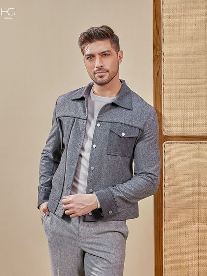 A closer look at the grey monochrome shacket, showing the texture of the fabric and the sharp tailoring that defines its effortless style.