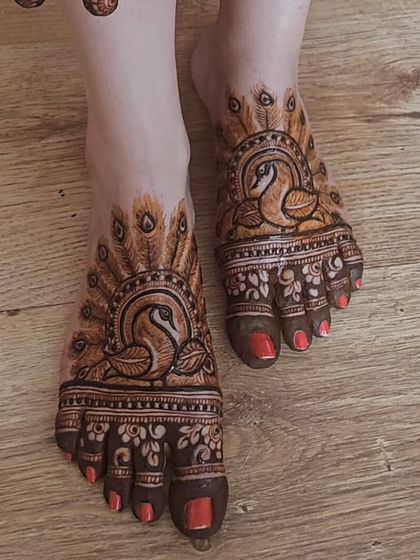 An elegant and unique foot design featuring swans with their feathers creating a beautiful fan pattern.