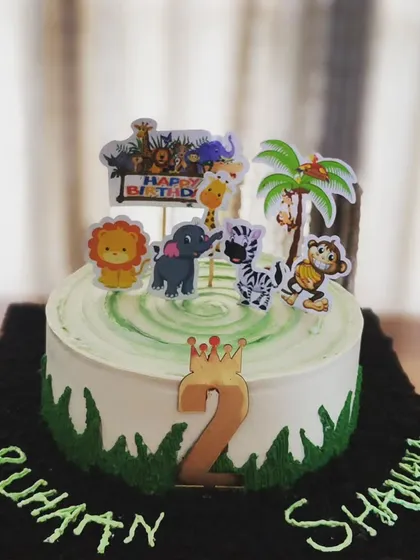 A fun jungle-themed chocolate cake I made for a set of twins turning two. I can customize cakes with any theme your child loves, complete with edible decorations and toppers to make their birthday extra special.