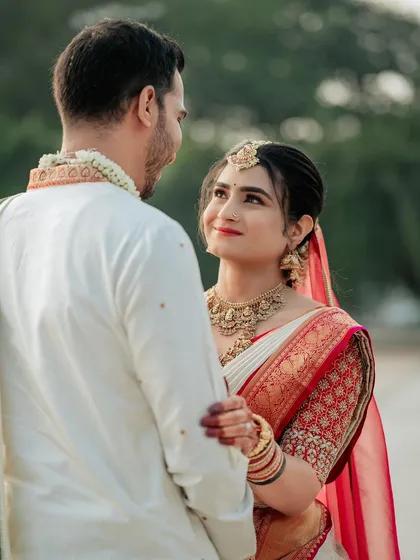 A romantic shot capturing the bride's elegant look. The custom blouse I created for her features detailed embroidery that echoes the richness of her Kanjivaram saree.