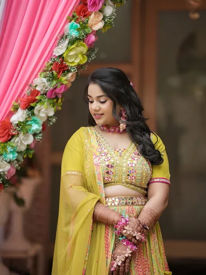 A candid moment of the Haldi bride, looking serene and beautiful. The soft makeup enhances her natural features perfectly.