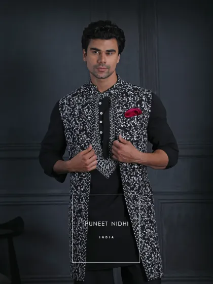 A classic black and white open-style Achkan. Detailed with bold patterns, contrast buttons, and a striking silhouette, the layered styling redefines tradition with modern ease.