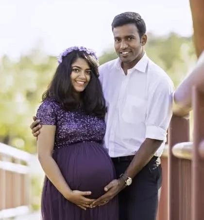 A smiling couple enjoying their outdoor maternity photoshoot. We capture the joy and partnership of expecting a child together.