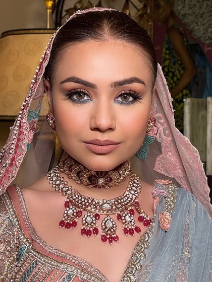 A close-up of the bride's flawless makeup and sleek hair.