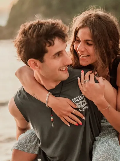 A happy, candid moment during a piggyback ride on a Bali beach. The genuine smiles and connection are what make our destination couple photography special.