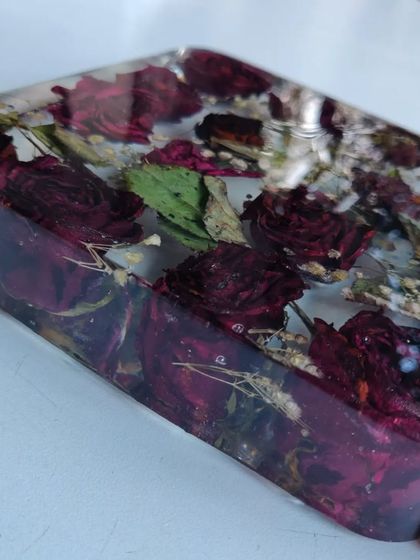 This resin block preserves a client's bouquet of roses, turning them into a permanent piece of art. The wooden base with an LED light makes the flowers glow beautifully.