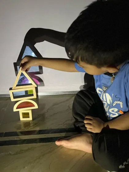 Shadow play is pure magic. Using a simple light source and translucent blocks, children can explore shapes, light, and reflection by building towers and seeing how their creations look on the wall.