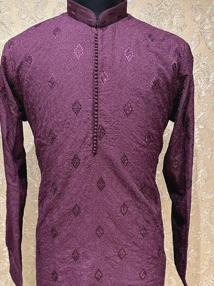 A deep wine-colored kurta with a textured, self-embroidered pattern. This rich color is perfect for an evening sangeet or cocktail party.