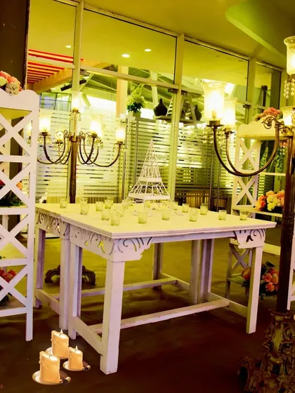 A cozy corner for conversation. I designed this seating area with white vintage-style furniture and candelabras to create an intimate and romantic atmosphere.