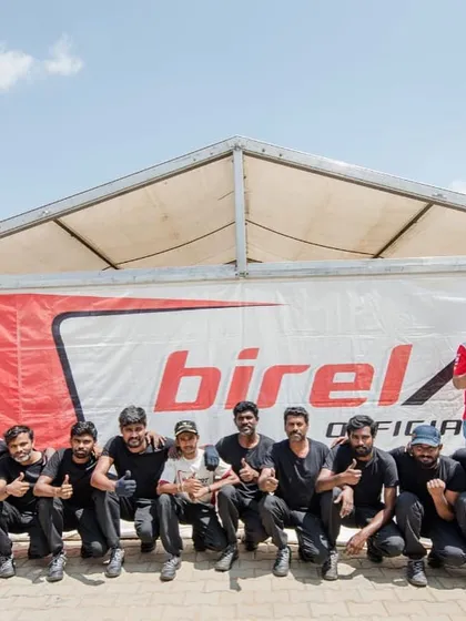 A group photo of our dedicated team, celebrating a successful race weekend with thumbs up all around.