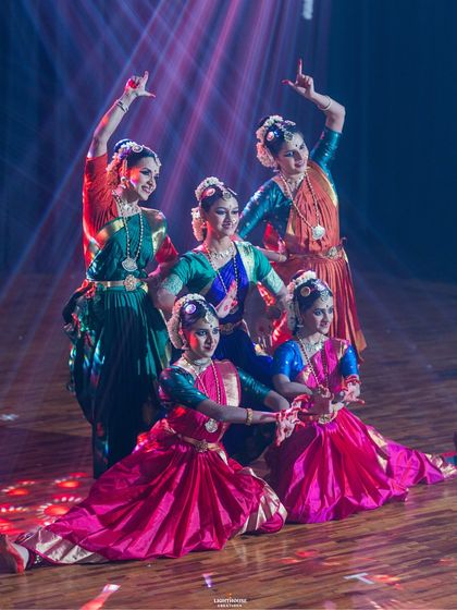 A colourful and dynamic moment from our Margam 2025 performance. The stage lighting highlights the beautiful costumes and intricate poses of the dancers.