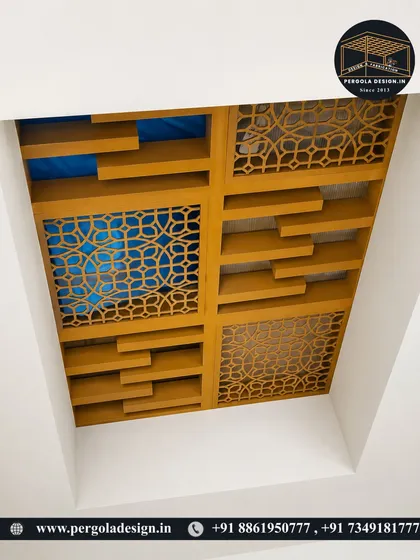 A unique view from below, looking up at a custom-designed ceiling with CNC-cut panels and wooden slats, currently under construction.