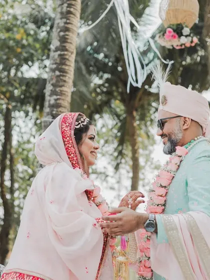A playful moment during the varmala ceremony at a beautiful Goa wedding. Capturing the fun and candid interactions is key to our storytelling approach.