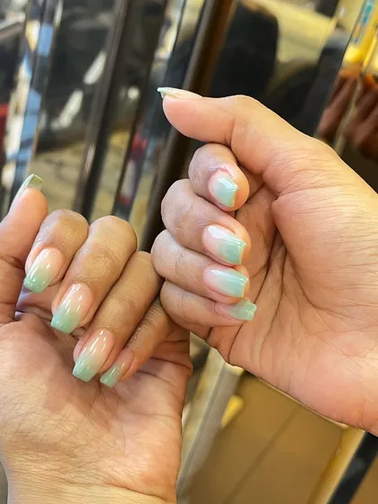 This manicure features a soft and subtle ombre effect with a mint green color. The gentle fade from a natural base to the pastel tip creates a fresh, clean, and modern look.