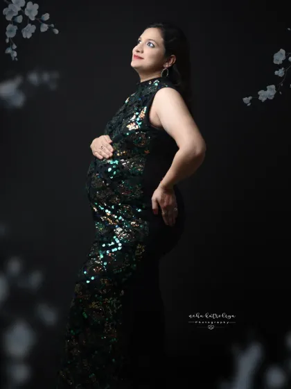 A glamorous look with a full-sequin gown. The way the light catches the sequins creates a dazzling effect against the dark background.