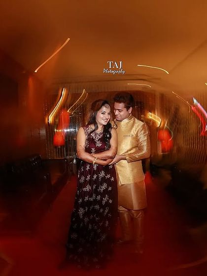 A creative shot using a slow shutter speed to create a whirlwind of light around the couple. This technique adds a dynamic and energetic feel to this indoor portrait.