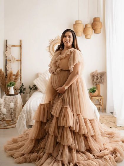 This wide shot really shows off the incredible detail and volume of this ruffled gown. It fills the frame so beautifully, creating a truly show-stopping solo maternity portrait.