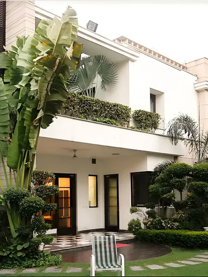 A backyard designed to be a private oasis, blending the comforts of home with the serenity of the outdoors. The lush, sculpted greenery provides a natural embrace.