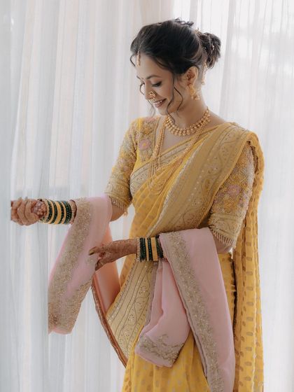 The bride looking at her beautiful saree, a perfect candid moment.