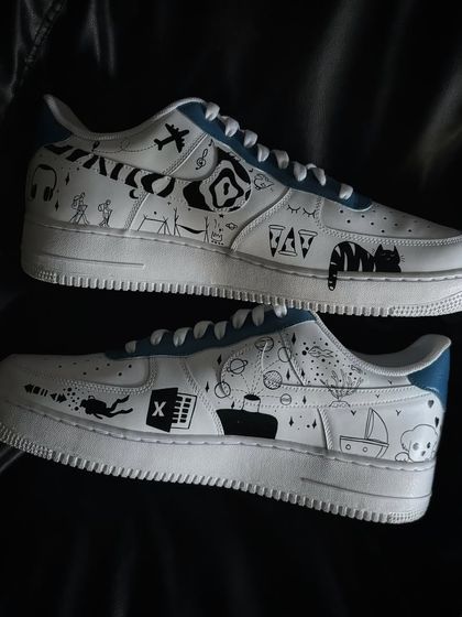 The full pair of the doodle custom sneakers, showing different designs on each shoe.