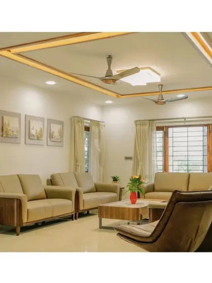 A view into a modern living room where functionality and comfort are key. The design uses a warm, neutral palette, clean lines, and thoughtful lighting, including a recessed ceiling feature, to create an inviting and spacious family area.