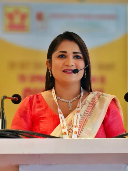 A close-up shot from the Deepak Publishers event. As a host, clear communication and a warm, professional expression are key to connecting with the audience during formal presentations.