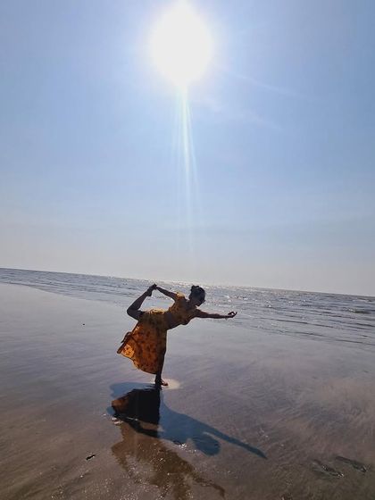 Yoga on the beach. A beautiful Natarajasana (dancer's pose) against the sun, embodying grace and balance.