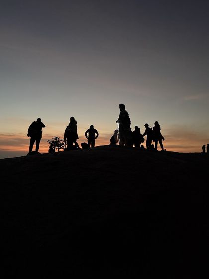 A silhouette of our group against the dawn sky at Uttari Betta, just before the sun appears.