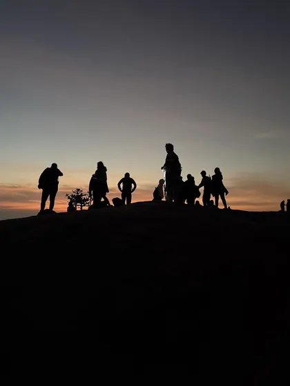 A silhouette of our group against the dawn sky at Uttari Betta, just before the sun appears.