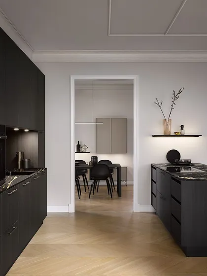 A view from the living area into the Black Fine Oak kitchen, showing how the dark, sophisticated design can be a stunning feature in an open-plan home.