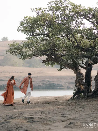 Capturing the journey is as important as the destination. Here, Tanuj and Tanya walk hand-in-hand, lost in their own world against the serene Lonavala backdrop. A simple, candid moment that speaks volumes about their bond.