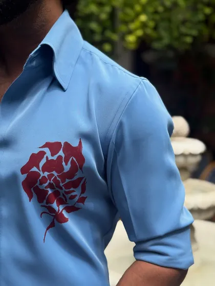 A detailed shot of the hand-painted motif on the chest and the quality of the shirt's fabric and construction.