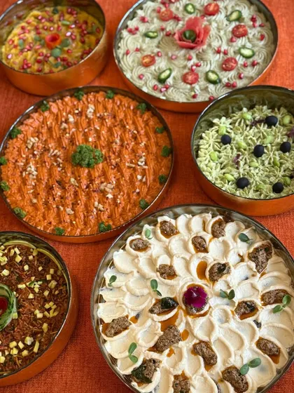 I believe dips should be as beautiful as they are delicious. This platter showcases a variety of my housemade dips, including a vibrant orange Muhammara and a creamy spiced hummus, each garnished to perfection.