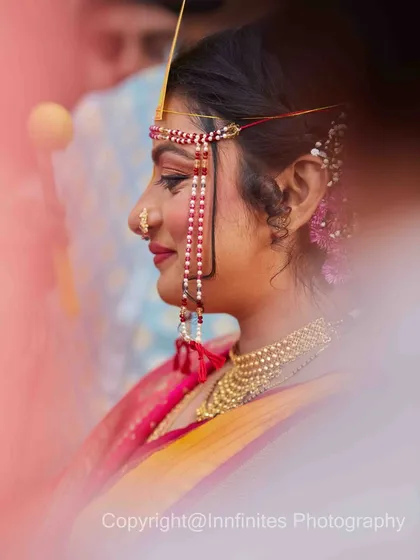 I used a soft focus and foreground blur to create this artistic and dreamy portrait of the bride. It highlights her traditional nose ring and serene profile.