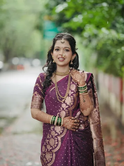 A full-length portrait of the bride-to-be. Her confident posture and happy smile show she's ready to celebrate her special day.