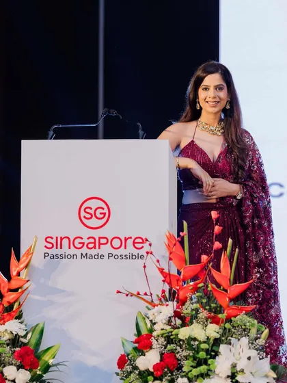 A moment of pride, standing by the podium at the Singapore Tourism event. I work to embody the spirit of the brand I am representing.