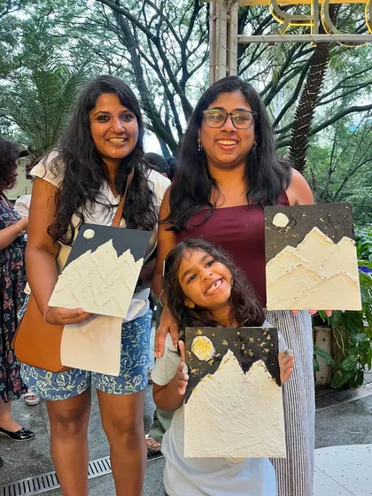 A family proudly displaying their mountain texture art. It’s a wonderful activity for parents and children to do together.