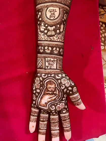 This design for a mom-to-be features a portrait of a sleeping baby on the palm. The arm includes a 'Girl or Boy' theme and a message in Marathi, 'Koni tari yenar aahe' (Someone is coming).