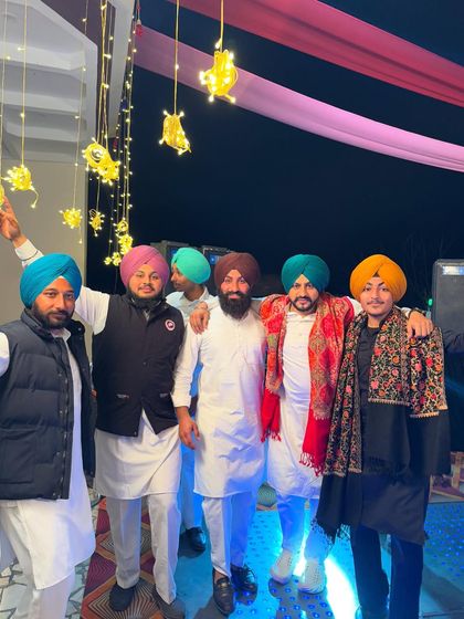 Posing with the boys at a Jaggo night. The vibrant turbans and traditional outfits add so much to the festive atmosphere.