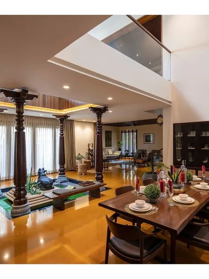 For our "Between Two Trees" project, we integrated traditional Indian architecture into a modern home. This central courtyard, featuring authentic Chettinad pillars and a stone Nandi, acts as the spiritual and visual anchor for the entire house.
