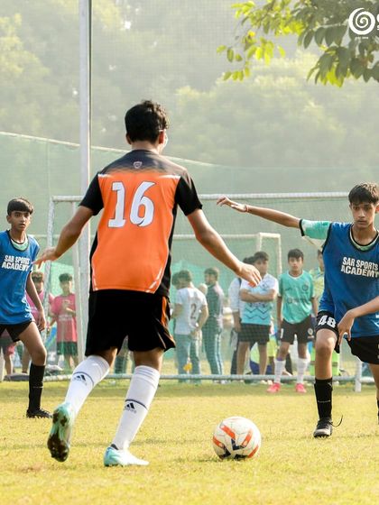 Two players position themselves to receive the ball, anticipating the next play.