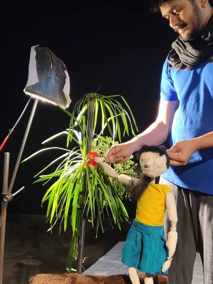A glimpse into our creative process. Here, we are setting up a scene with simple props and focused lighting.