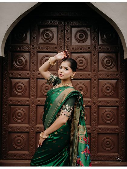 A striking pose that combines tradition with a touch of modern glamour. The bride's confidence shines through in this beautiful solo portrait.