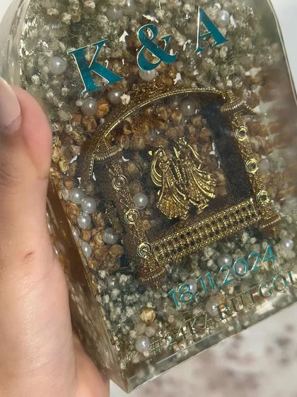 I love how the colors of the text can be customized. Here, the teal text adds a modern touch to the traditional kaleera and varmala preservation.
