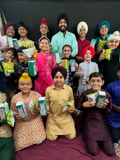 A colorful group of students in traditional wear, happy with their Children's Day gifts. We celebrate our culture and our kids with equal enthusiasm.