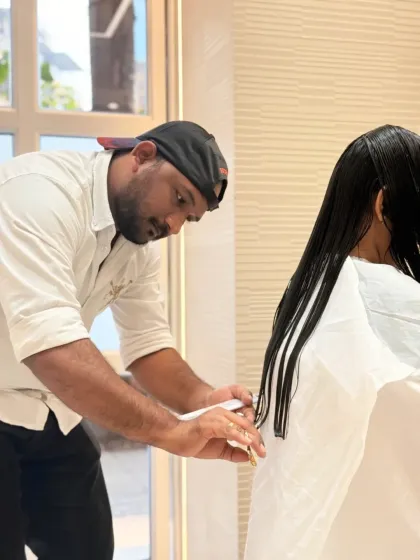Our team at work, making every client feel confident. Here, our stylist Raj is giving a client a sharp, clean haircut.