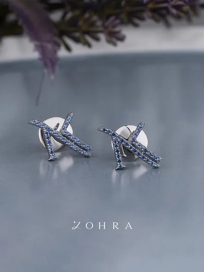Your name deserves to be worn as a celebration of who you are. These custom initial stud earrings are crafted in white gold and meticulously set with blue sapphires. They are an intimate and personal statement of your unique identity.