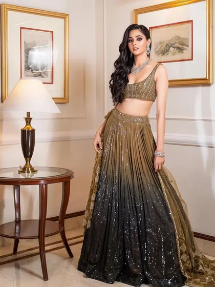 A full-length shot of a glamorous ombre sequin lehenga. The makeup is kept clean and sophisticated to balance the statement outfit.